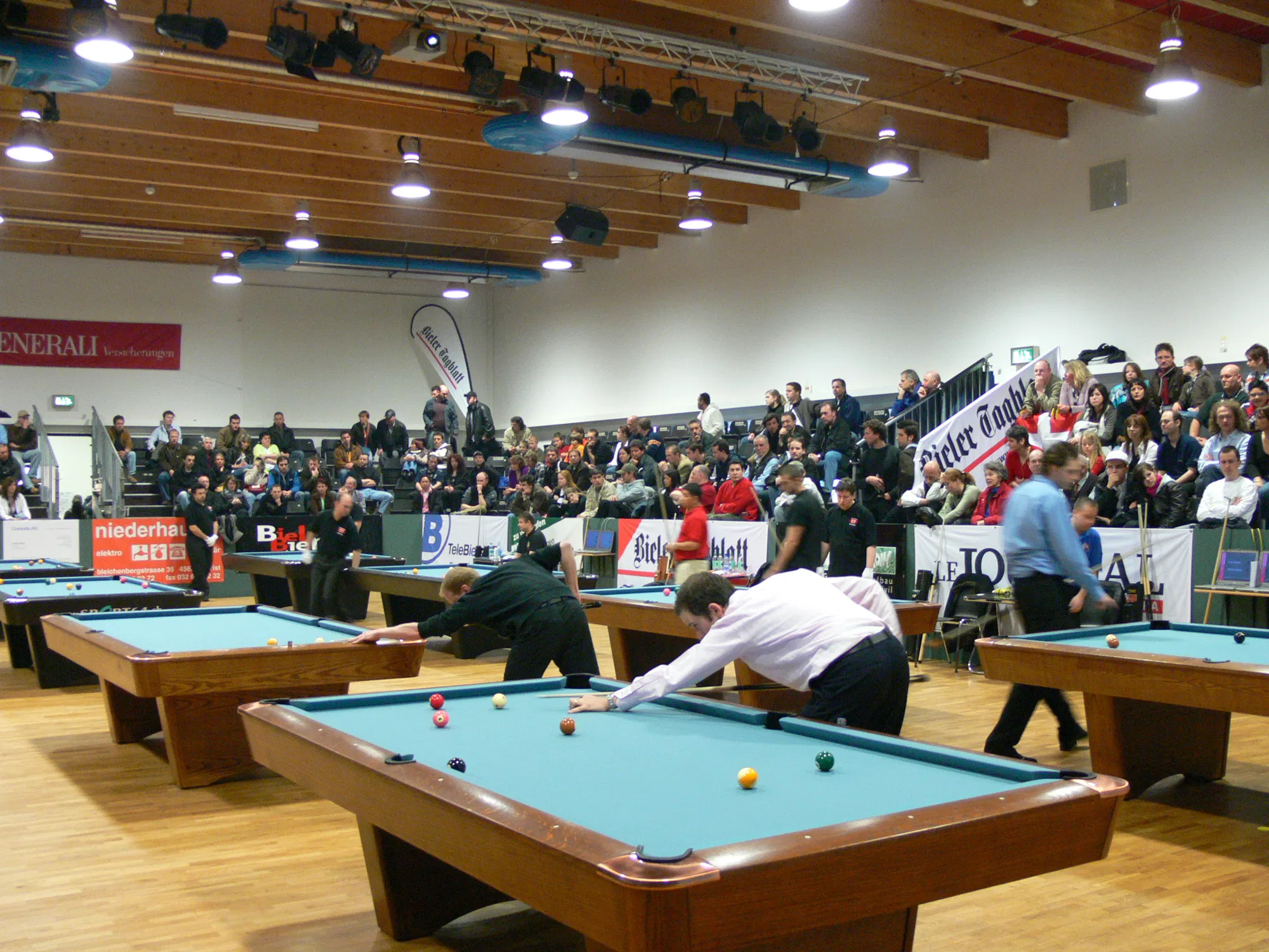 A packed billiards arena during a professional tournament
