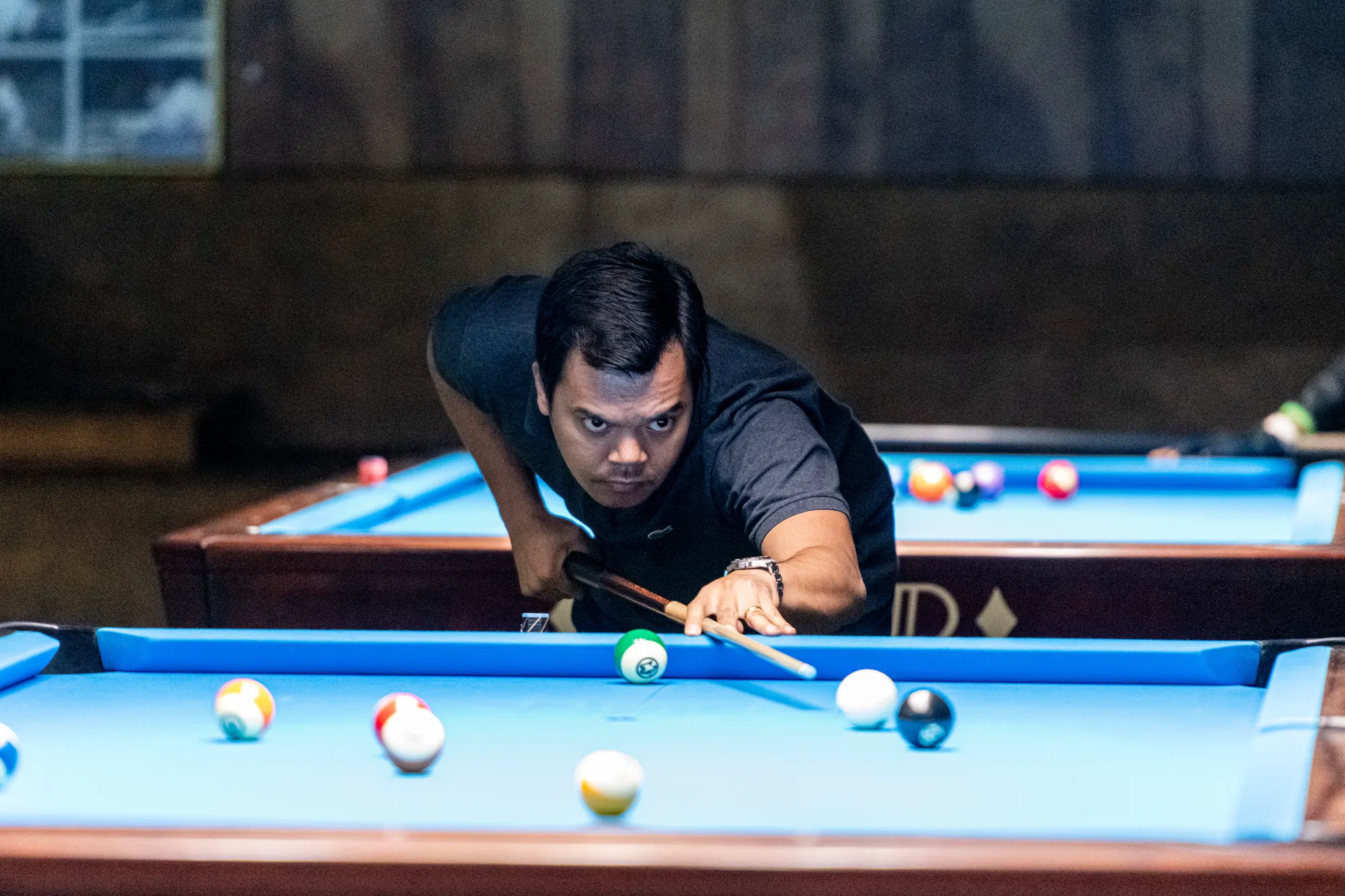 Carlo Biado lining up a shot at the 2022 International 9-Ball Open